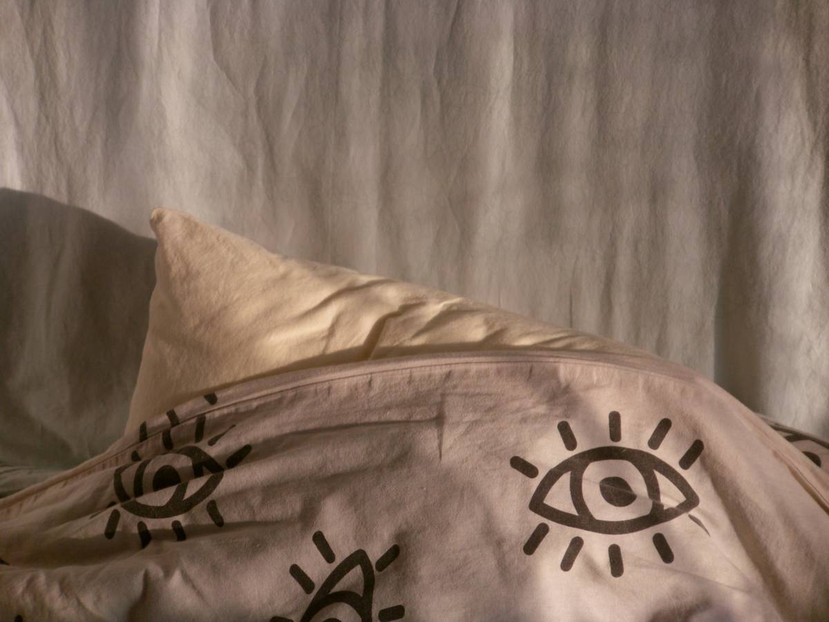 Close-up of relaxation aid reusable eye mask doe showing natural flaxseed fill and organic cotton cover