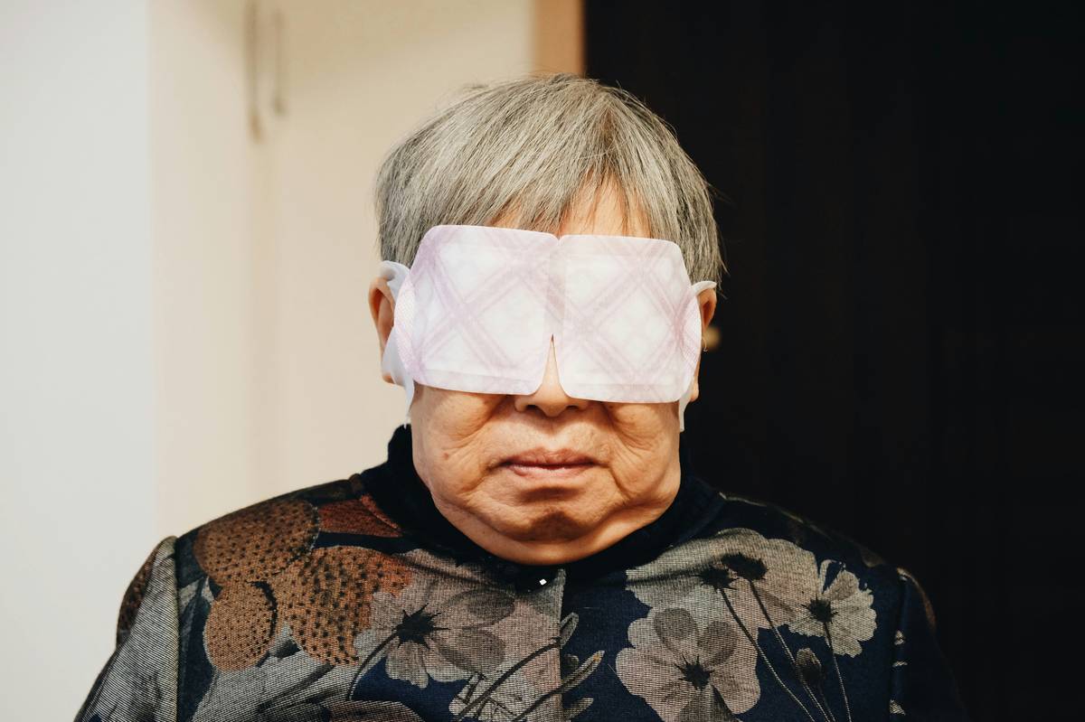 Woman applying reusable under eye mask after serum for maximum hydration